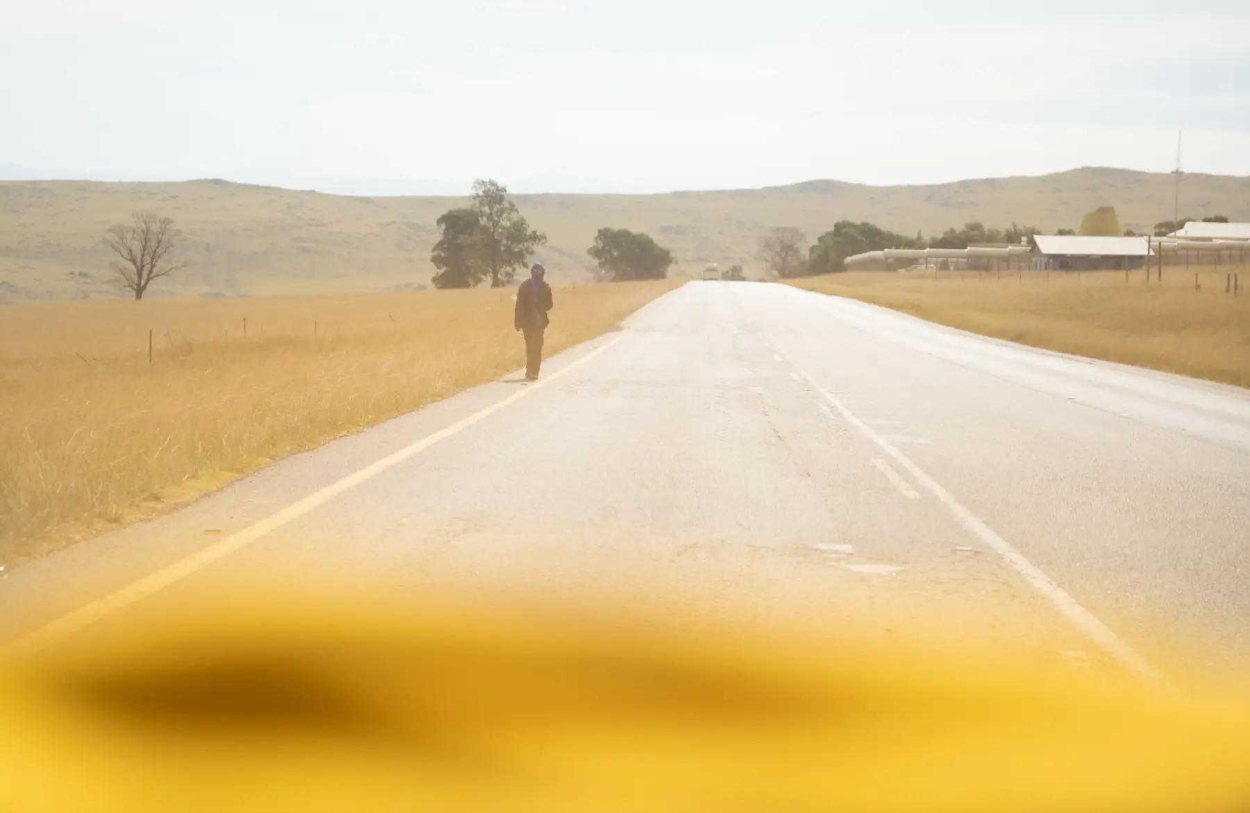 An open road stretching toward the hills